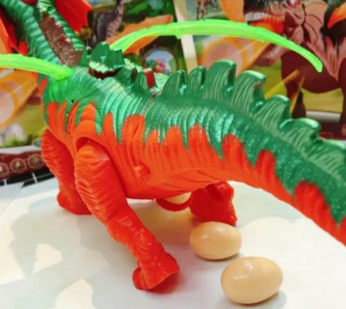Dinosaurio Naranja Con Proyector Y Pone Huevos Camina Luces Y Sonido