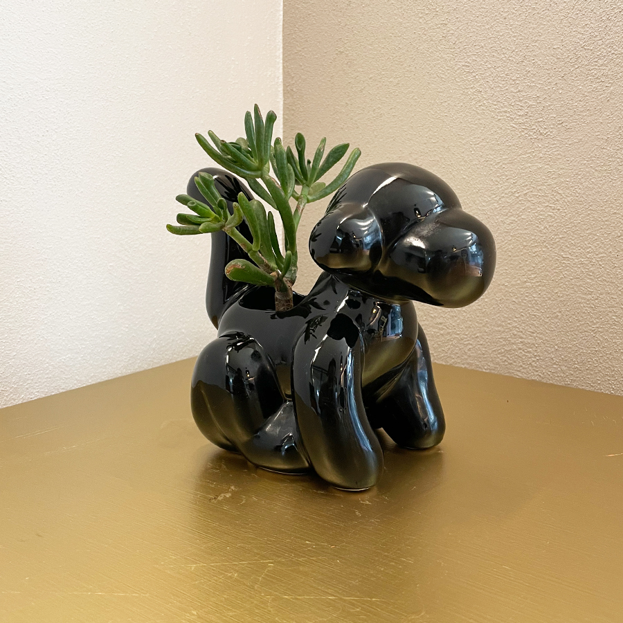 Maceta decorativa en forma de mono: elegancia y encanto en color negro brillante.