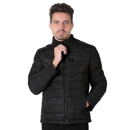 Un hombre con una chaqueta de camuflaje se para frente a un atv blanco y  negro.